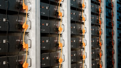 A closeup of interconnected battery modules in a stationary battery energy storage system.