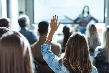 Woman raising her hand during a presentation